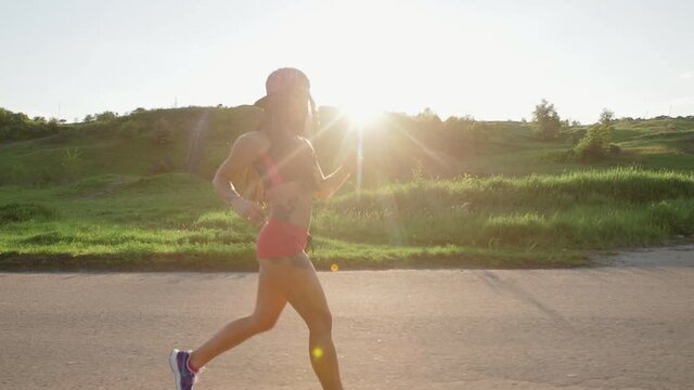 Fitness woman running, beautiful sunset landscape Slow Motion