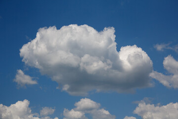 Naklejka na ściany i meble Blue sky with a cloud closeup. Nature