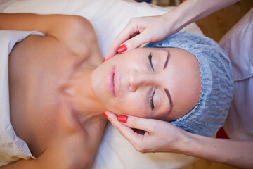Obraz na płótnie Canvas doctor cosmetologist doing facial massage girl spa