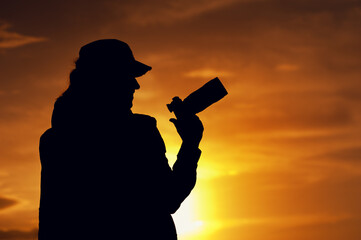 Silhouette of professional female photographer