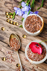 Flax seeds in spoons and bowl