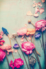 Pretty flowers retro pastel toned on vintage turquoise background, top view