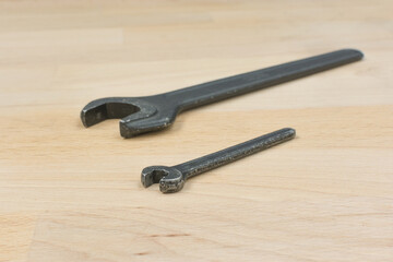 Two old spanners on a wooden table