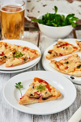 Italian Seafood pizza slice with mussels,tomatoes on a white plate. vertical