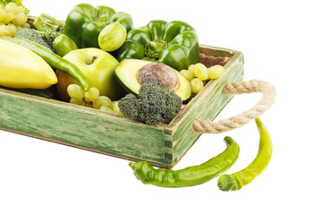 Set of different green vegetables and fruits in the wooden tray, isolated