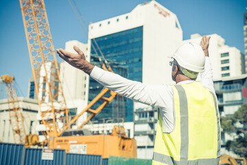 Senior foreman in glasses doing his job at building area on sunn