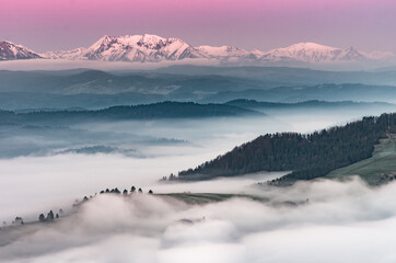 Beautiful spring panorama over misty Spisz highland to snowy Tatra mountains in the morning, Poland