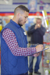 warehouse worker with clipboard in warehouse