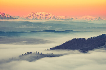 Beautiful spring panorama over misty Spisz highland to snowy Tatra mountains in the morning, Poland