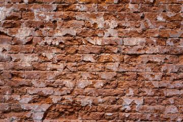 Ancient ruined brick wall, background or texture