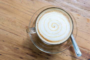 Cappuccino art cup of coffee on wooden table, Top view