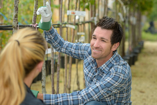 Nursery worker talking to woman