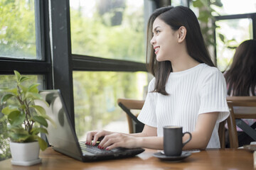 Obraz premium Beautiful business girl working with tablet , smartphone and drinking coffee in coffee shop