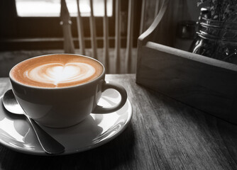 Hot coffee cup with warm morning light window, black and white tone with partial color layer picture