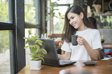 Fototapeta premium Beautiful business girl working with tablet , smartphone and drinking coffee in coffee shop