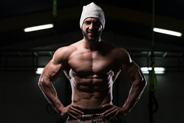Fototapeta na wymiar Muscular Bodybuilder Showing His Front Abdominal Abs