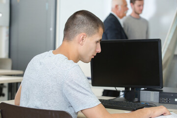 Male student using computer