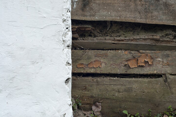 Old white wall with wooden boards