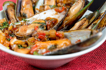 Mussel with white wine sauce on table
