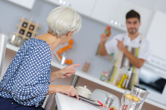 Man checking condiment for woman's meal