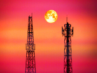 Obraz premium super blood moon between signal pillar in eveing light