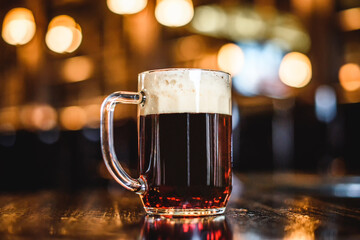 A glass of dark beer on counter