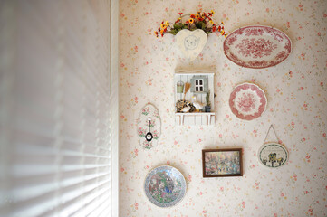 vintage style wall decoration with wallpaper beside of window