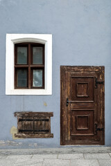 Vintage wooden entrance door and old windows.