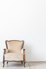 vintage armchair on white wall.