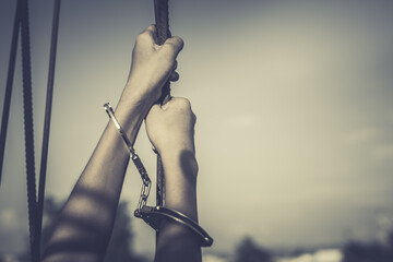 Female Hands with cage cell. trafficking Concept, focus blur.