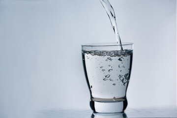 Pouring water into a glass