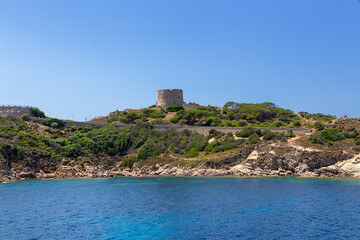 Fototapeta na wymiar The island of Sardinia, Italy. The tower of Longosardo (16th century) on a rocky shore near the town of Santa Teresa Gallura