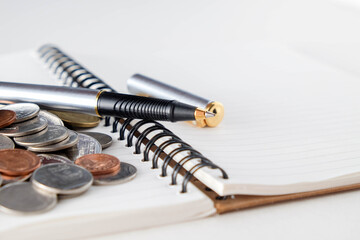 business finance. save money for investment concept coins and pen
