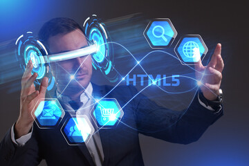 Business, Technology, Internet and network concept. Young businessman working in virtual reality glasses sees the inscription: HTML5
