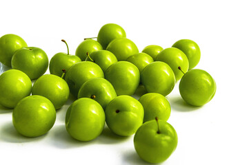 Sour plum pictures on white ground, wonderful sour plums, green plums pictures from the first fruits in summer
