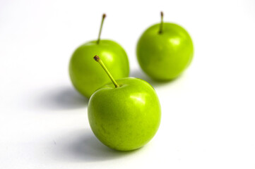 Sour plum pictures on white ground, wonderful sour plums, green plums pictures from the first fruits in summer

