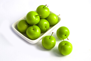 Sour plum pictures on white ground, wonderful sour plums, green plums pictures from the first fruits in summer
