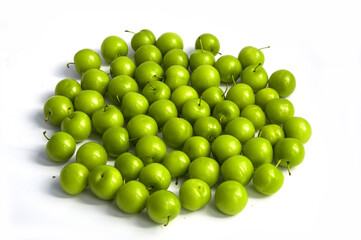 Sour plum pictures on white ground, wonderful sour plums, green plums pictures from the first fruits in summer
