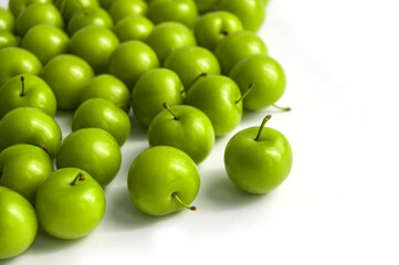 Sour plum pictures on white ground, wonderful sour plums, green plums pictures from the first fruits in summer
