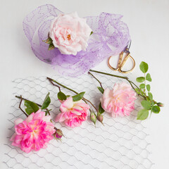 Roses on chicken wire with rose wrapped in seqiuns on white canvas background
