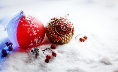 Ornate christmas balls in snow with blue backlight.