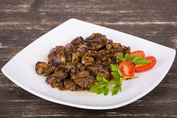 Chicken livers in a creamy sauce with onion on white plate