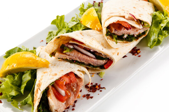 Spring rolls - wraps with meat and vegetables on white background 