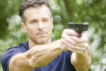 Man using pistol outdoor