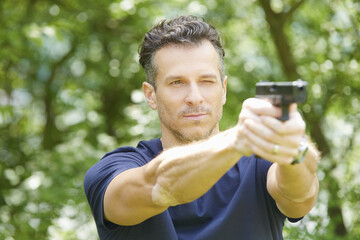 Man using pistol outdoor