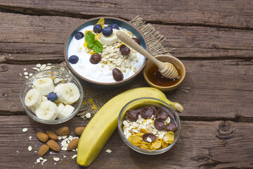 healthy breakfast - muesli with fruit, yogurt and honey