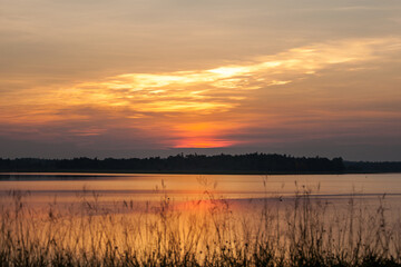Beautiful stormy sunset. Fiery orange sunset sky.