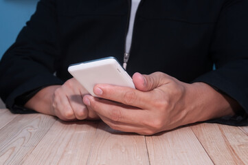 Unidentified business man using smartphone for communicate with another people.