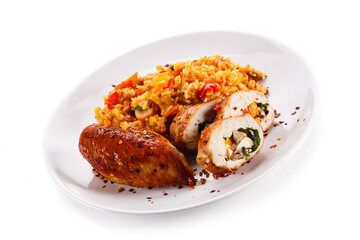 Stuffed chicken fillet with rice and vegetables on white background 