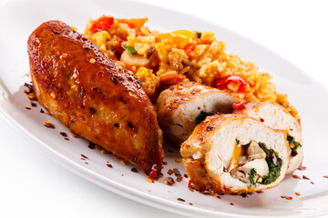 Stuffed chicken fillet with rice and vegetables on white background 